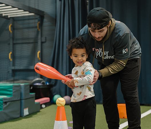 young boy playing t ball at kids gym