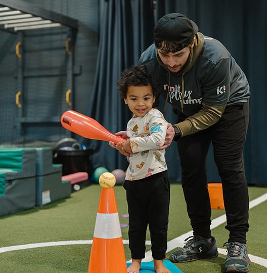 young boy playing t ball at kids gym
